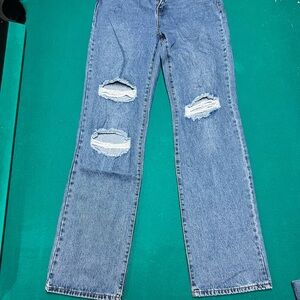 High-waisted wide leg blue denim jeans with distressed details